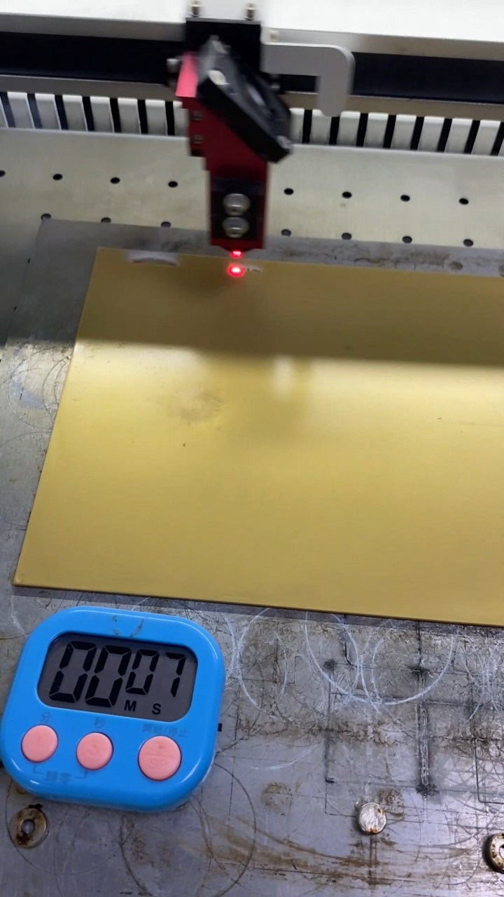 POM sheet positioned in the DF60D CO2 laser with an independent timer visible