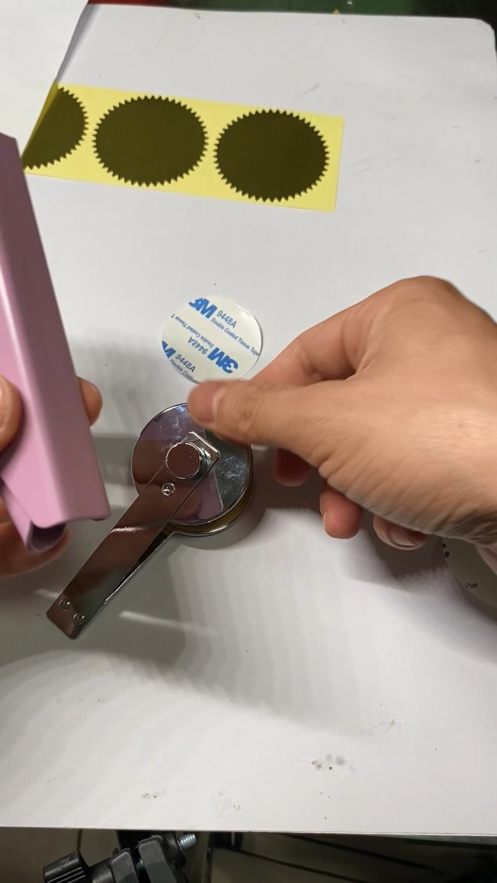 POM die set being installed and aligned in a handheld embosser