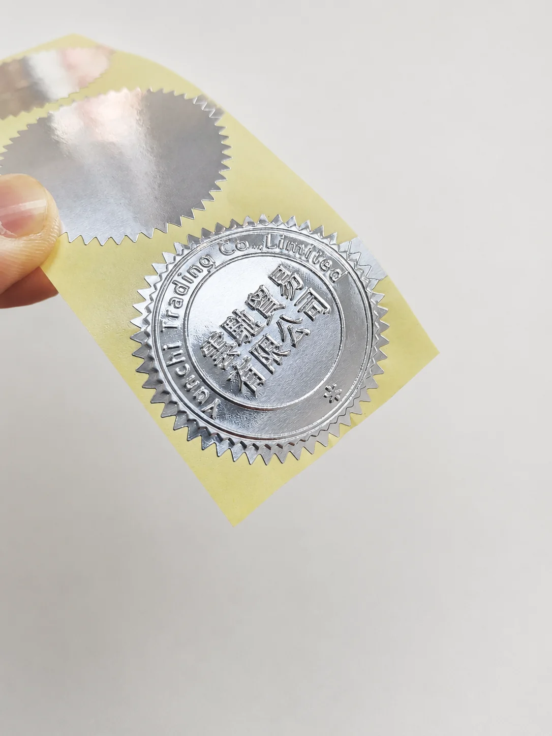 Custom logo embossing result produced from matched POM dies