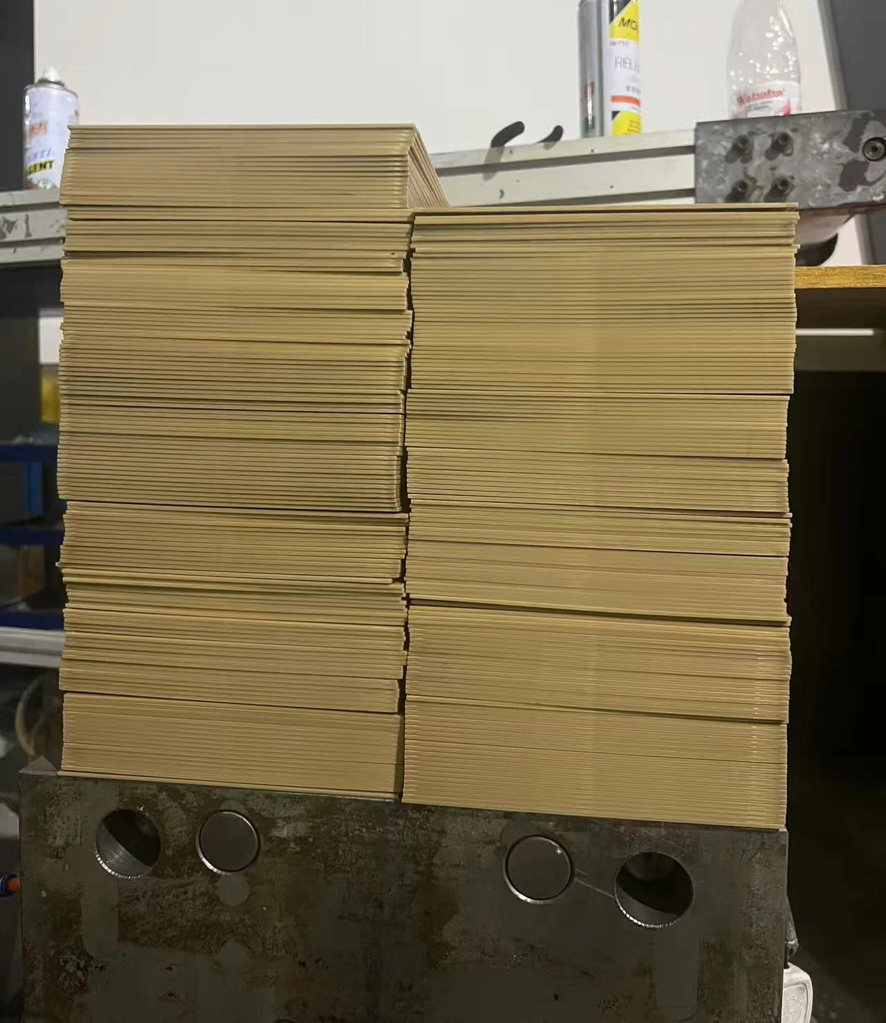 Stacked gold-colored POM sheets for embosser die manufacturing